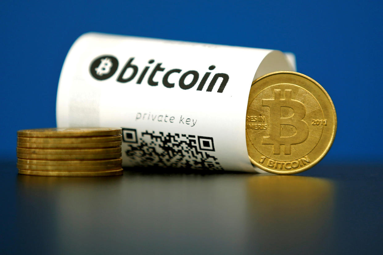 A Bitcoin (virtual currency) paper wallet with QR codes and a coin are seen in an illustration picture shot May 27, 2015. (REUTERS/Benoit Tessier/Illustration/File Photo)