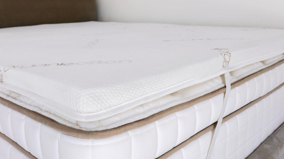 A closeup of the Saatva Natural Latex Mattress topper on a bed