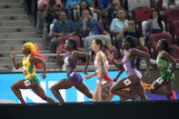 Shelly-Ann Fraser-Pryce, of Jamaica, left, leads in a Women's 100-meter semifinal during the World Athletics Championships in Budapest, Hungary, Monday, Aug. 21, 2023. (AP Photo/Matthias Schrader)