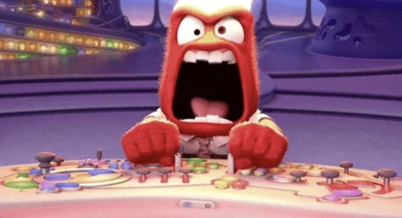 Anger from Inside Out is shown in a control room with an angry expression and hands on levers