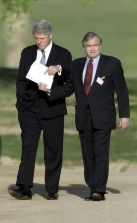 U.S. President Bill Clinton (L) is passed a note by National Security Advisor Sandy Berger as they take a stroll during a break in the peace summit at Sharm El Sheikh in this October 16, 2000 file photo. REUTERS/Dylan Martinez/Files