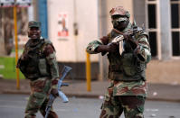 <p>Soldiers open fire to disperse crowds of the opposition Movement for Democratic Change supporters outside the party’s headquarters in Harare, Zimbabwe, August 1, 2018. (Photo: Mike Hutchings/Reuters) </p>