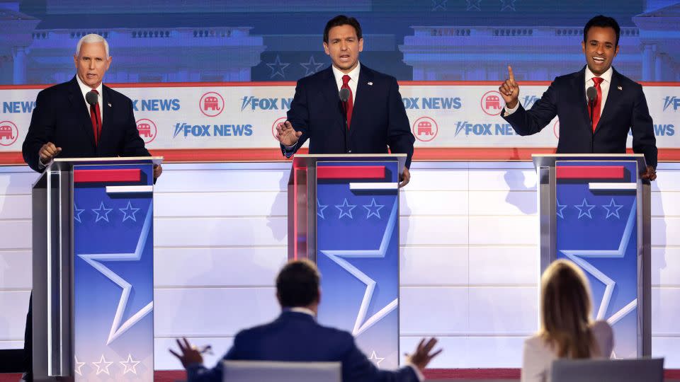 DeSantis, flanked by former Vice President Mike Pence, left, and entrepreneur Vivek Ramaswamy participate in the first GOP primary debate in Milwaukee on August 23, 2023.  - Win McNamee/Getty Images