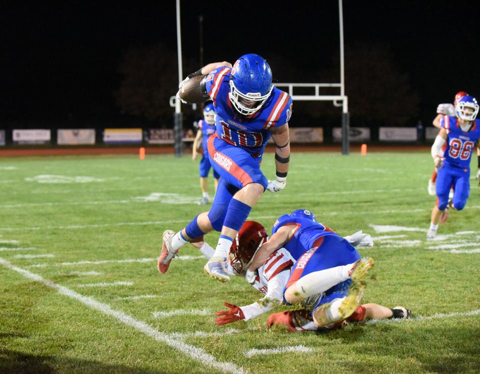 Lenawee Christian's Easton Boggs (10) leaps over a block on Oct. 27, 2023, during a Division 2 8-Player regional game against Camden Frontier.