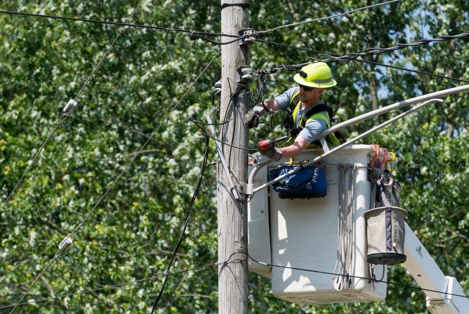 An Ameren Illinois employee works to restore power to the Village of Keensburg, Ill., Friday, May 20, 2022. Heavy storm winds came through the area Thursday night causing significant damage. 