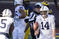 Penn State quarterback Sean Clifford (14) celebrates his team's win over Michigan with wide receiver Jahan Dotson (5) after an NCAA college football game, Saturday, Nov. 28, 2020, in Ann Arbor, Mich. (AP Photo/Carlos Osorio)