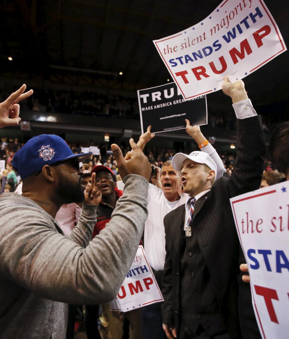 Trump supporter (R) exchanges words with a demonstrator (L) after Republican U.S. presidential candidate Donald Trump cancelled his rally at the University of Illinois at Chicago March 11, 2016. (REUTERS/Kamil Krzaczynski)