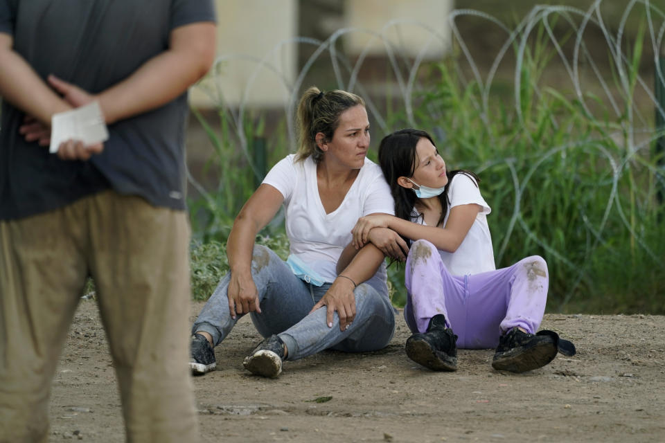 Migrants wait to be processed by the Border Patrol after illegally crossing the Rio Grande river from Mexico into the U.S. at Eagle Pass, Texas, Friday, Aug. 26, 2022. The area has become entangled in a turf war between the Biden administration and Texas Gov. Greg Abbott over how to police the U.S. border with Mexico. (AP Photo/Eric Gay)