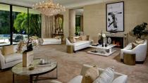 <p>The formal sitting room has a gorgeous marble fireplace and crystal chandelier.</p>