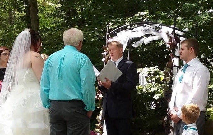 Adam Leech, center, officiates an outdoor wedding. Leech started Marry Me in Maine, a new wedding-officiating business, in February of 2023. He has been licensed to marry couples since 2017.