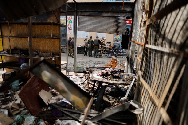 FILE PHOTO: Ukrainian military officers and civilians shop at a street market in Bakhmut