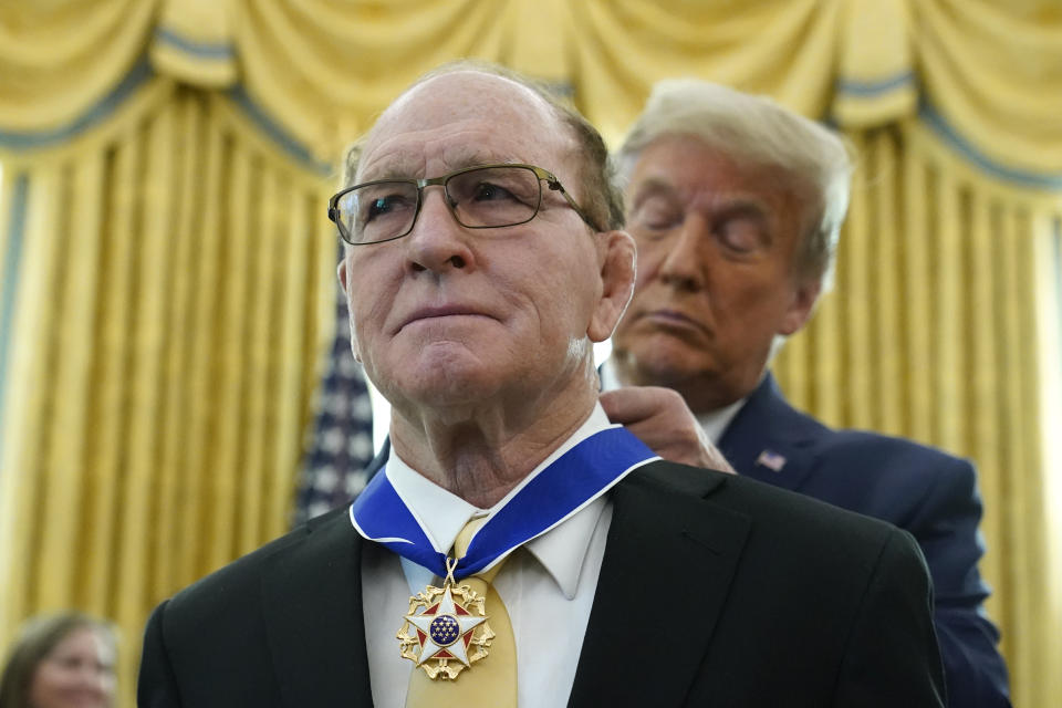 President Donald Trump awards the Presidential Medal of Freedom, the highest civilian honor, to Olympic gold medalist and former University of Iowa wrestling coach Dan Gable in the Oval Office of the White House, Monday, Dec. 7, 2020, in Washington. (AP Photo/Patrick Semansky)