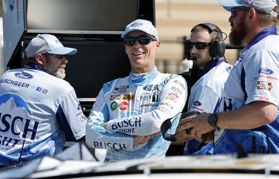 Kevin Harvick, center, visits his crew along pit road before practice for a NASCAR Cup Series auto race at Kansas Speedway in Kansas City, Kan., Saturday, May 14, 2022. (AP Photo/Colin E. Braley)