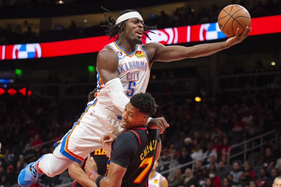 Oklahoma City Thunder forward Luguentz Dort fouls Atlanta Hawks guard Jarrett Culver during the first half of an NBA basketball game, Monday, Dec. 5, 2022, in Atlanta. (AP Photo/Hakim Wright Sr.)