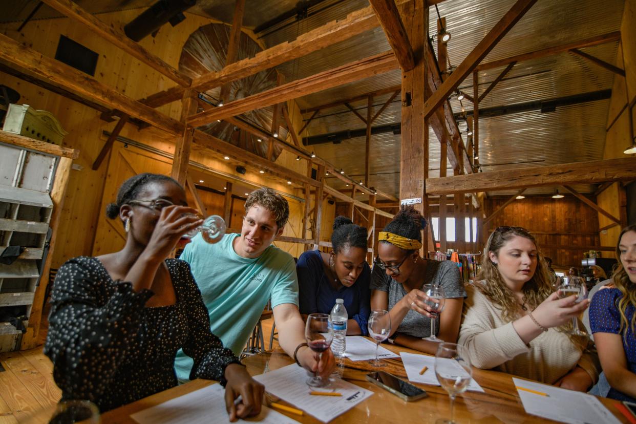 Customers enjoy the wine and the atmosphere of Bishop Estate Vineyard and Winery's historical barn & our "coop" area, which is one of many tasting areas on the Perkasie farm.