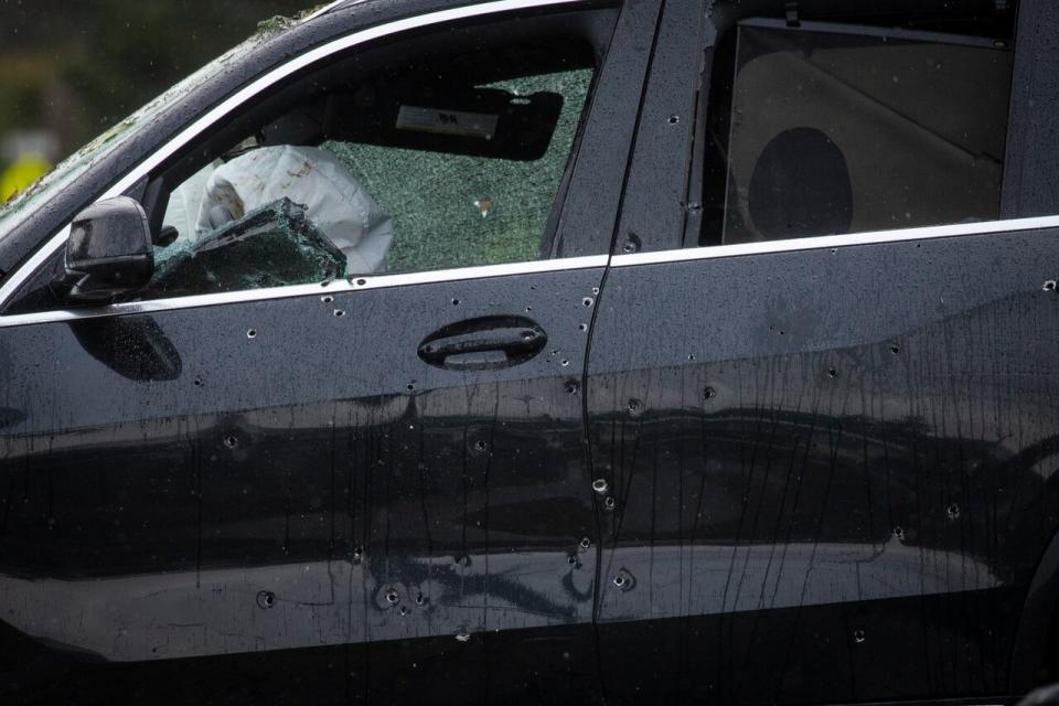 Multiple bullet holes are visible inthe black BMW SUV that crashed at the scene of a shooting near Roper and Parker in White Rock, British Columbia on Thursday, February 22, 2023. 