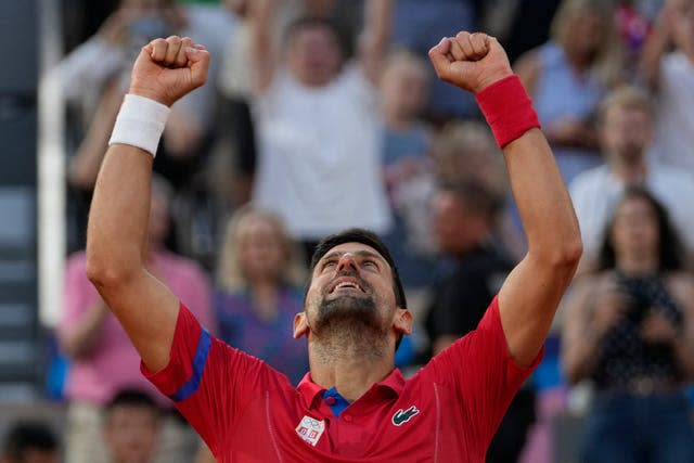 Novak Djokovic holds his arms aloft