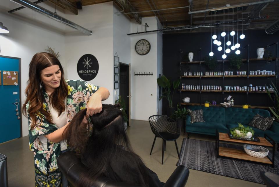 Headspace Beauty Lounge owner Michelle McKnight works on a client's hair, Thursday, Agu. 17, 2023.