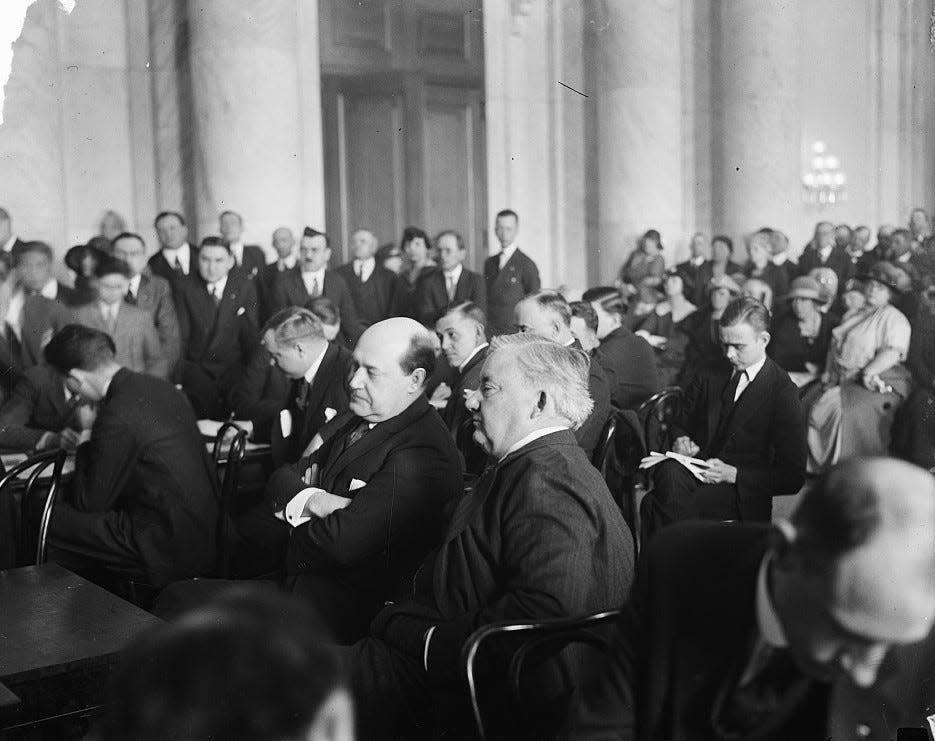 Harry F. Sinclair, multimillionaire oil magnate, left, and his counsel Martin W. Littleton are pictured during Teapot Dome hearing in the 1920s.