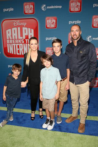 <p>Jesse Grant/Getty</p> Melissa Joan Hart, husband Mark Wilkerson and their three kids in 2018