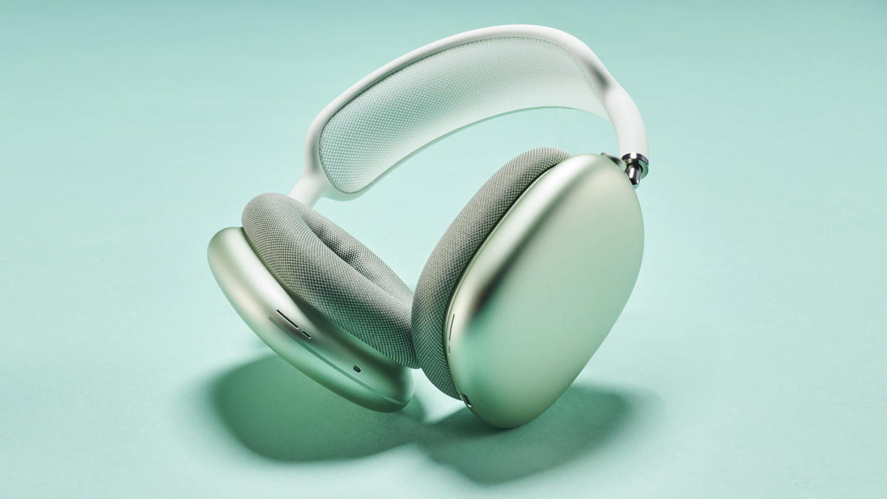  Apple AirPods Max headphones in silver finish on a minty teal background. 