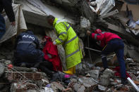 <p>Emergency teams search for people through the rubble of a destroyed building in Adana, Turkey, Monday, Feb. 6, 2023. A powerful quake has knocked down multiple buildings in southeast Turkey and Syria and many casualties are feared. (AP Photo/Khalil Hamra)</p> 