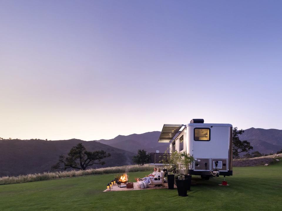 the 2022 Living Vehicle trailer outside on a patch of grass with an outdoor setup