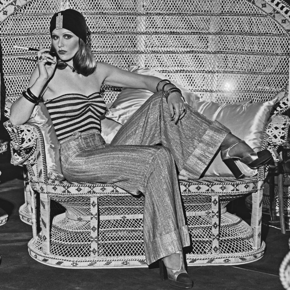 A model wearing wide-legged trousers, a striped tube top and a turban-style hat at the Biba boutique in London, UK, 6th September 1973