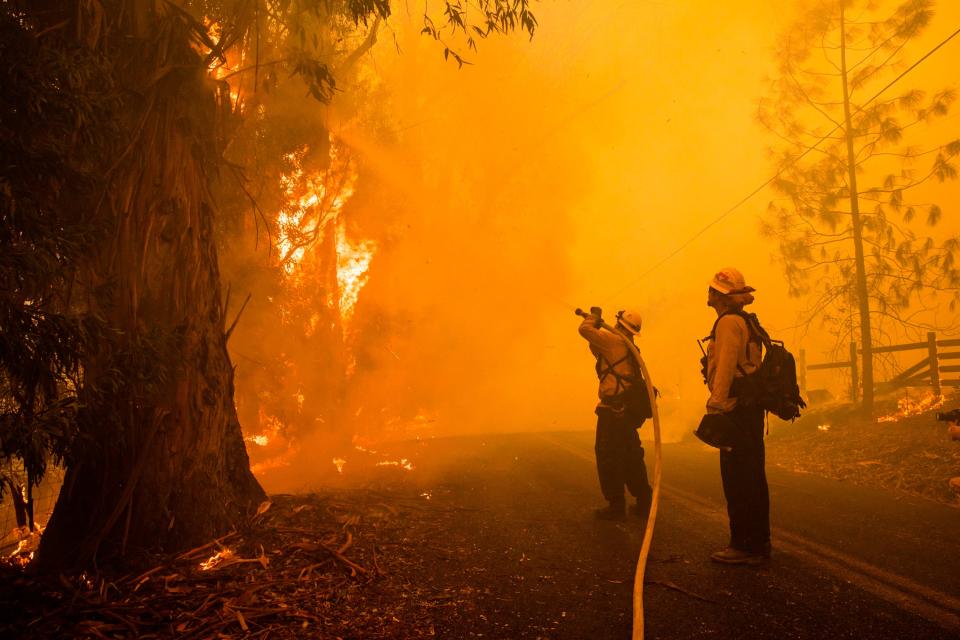 Firefighters battle the Kincade Fire along Chalk Hill Road in Healdsburg, California, on Oct. 27, 2019.