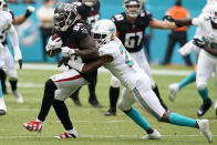 Miami Dolphins free safety Eric Rowe (21) tackles Atlanta Falcons running back Cordarrelle Patterson (84) during the second half of an NFL football game, Sunday, Oct. 24, 2021, in Miami Gardens, Fla. (AP Photo/Wilfredo Lee)