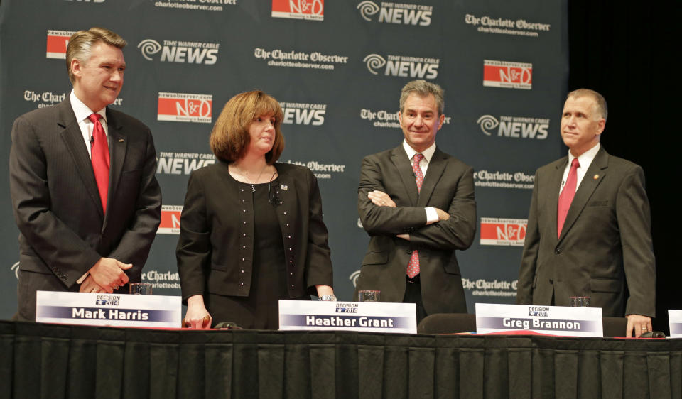 Republican senatorial candidates, from left, Mark Harris, Heather Grant, Greg Brannon, and Thom Tillis, arrive at their spots before a debate at Davidson College in Davidson, N.C., Tuesday, April 22, 2014. (AP Photo/Chuck Burton)