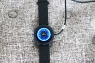 <p>OnePlus Watch review photos. OnePlus Watch on a charger with display showing 47 percent battery and time at 1:38pm.</p> 