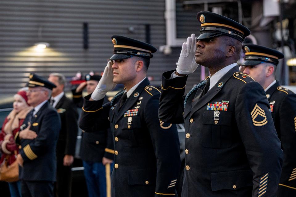 The remains of Lt. John Heffernan, a WW2 US bomber navigator who was shot down in Burma in 1944, arrive at Newark Liberty Airport on Tuesday November 15, 2022. Members of the Honor Guard salute as Heffernan's casket arrives on the plane. (From left) Ssg. Rodriguez and Sfc. Williams.