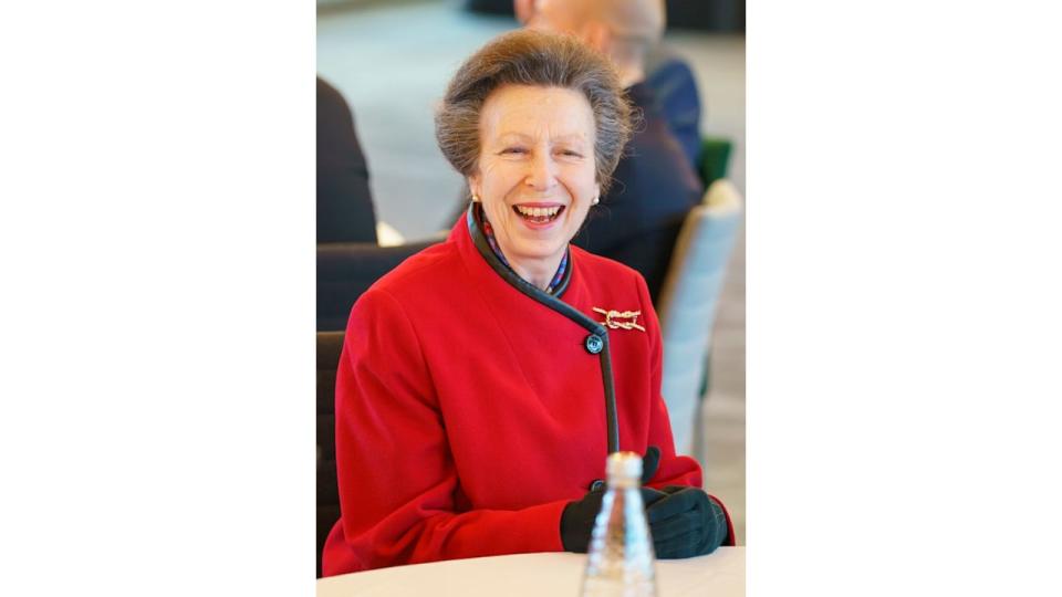 Princess Anne wearing red coat and smiling