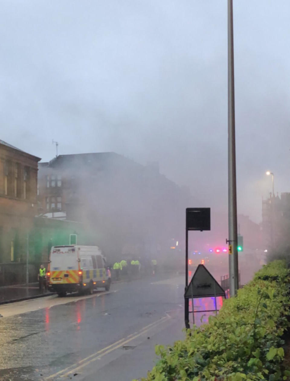 Smoke flares from Govan Road, Glasgow during trouble at an Irish unity march and counter protest (Picture: PA)