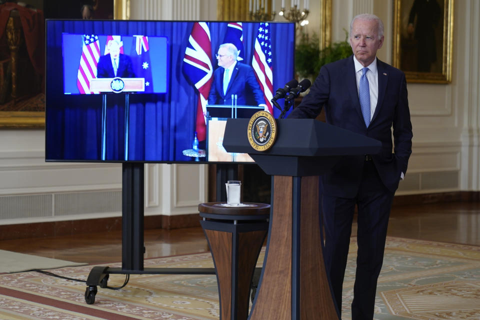 President Joe Biden, joined virtually by Australian Prime Minister Scott Morrison, right on screen, and British Prime Minister Boris Johnson, speaks about a national security initiative from the East Room of the White House in Washington, Wednesday, Sept. 15, 2021. (AP Photo/Andrew Harnik)