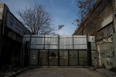 A Greek national flag waves at the entrance of an old naval base where the construction of the first formal mosque has started, in Athens, Greece, February 6, 2017. REUTERS/Alkis Konstantinidis