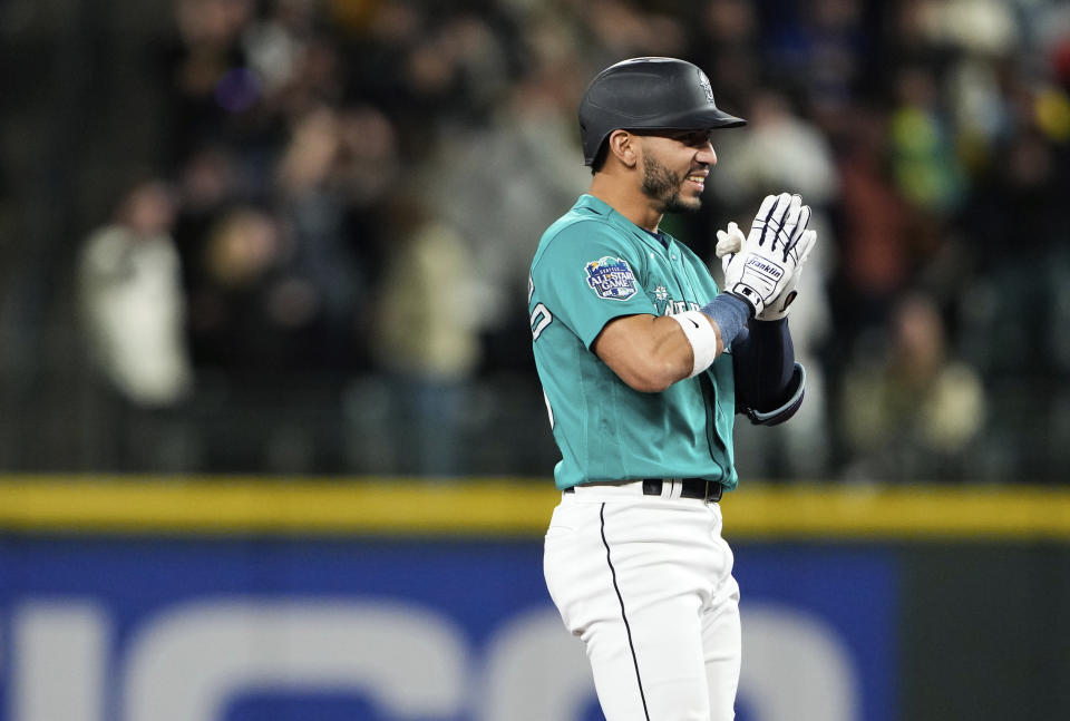 Seattle Mariners' Jose Caballero reacts after hitting a two-run double against the Houston Astros during the eighth inning of a baseball game Saturday, May 6, 2023, in Seattle. (AP Photo/Lindsey Wasson)