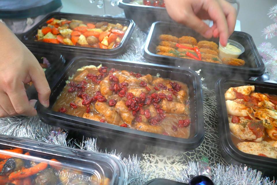 hows catering - placing food back into the container