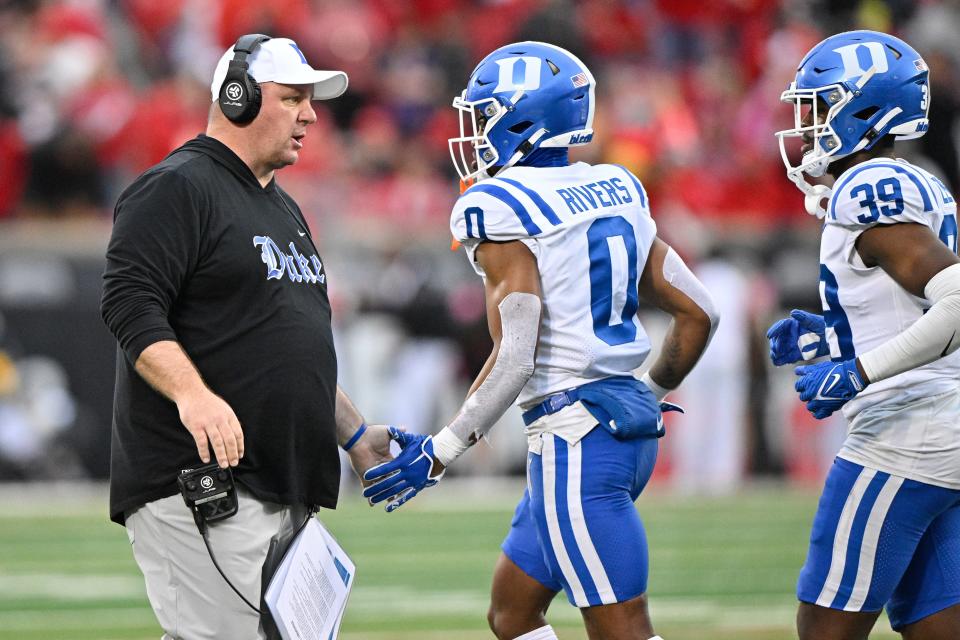 Oct 28, 2023; Louisville, Kentucky, USA; Duke Blue Devils head coach Mike Elko talks with cornerback Chandler Rivers (0) during the second half against the Louisville Cardinals at L&N Federal Credit Union Stadium. Mandatory Credit: Jamie Rhodes-USA TODAY Sports