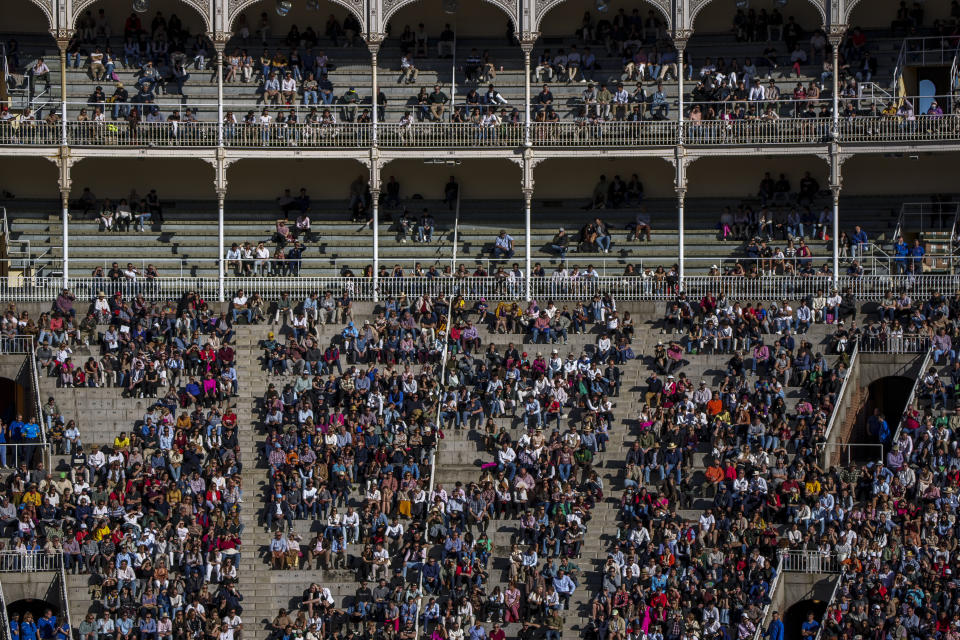 Spectators watch a bullfight with small bulls at Las Ventas bullring in Madrid, Spain, Sunday, March 26, 2023. The death of Spanish bullfighting has been declared many times, but the number of bullfights in the country is at its highest level in seven years, and the young are the most consistent presence as older groups of spectators drop away. (AP Photo/Manu Fernandez)