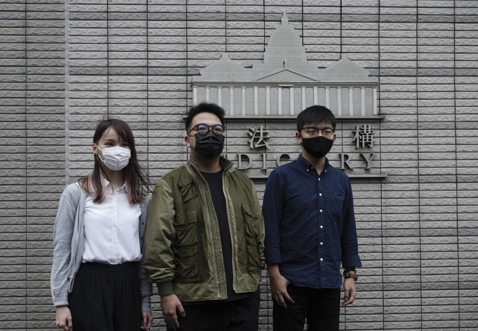 Hong Kong activists, from right, Joshua Wong, Ivan Lam and Agnes Chow arrive at a court in Hong Kong, Monday, Nov. 22. 2020. The trio appears at court for their trial as they face charges related to the besieging of a police station during anti-government protests last year. (AP Photo/Vincent Yu)