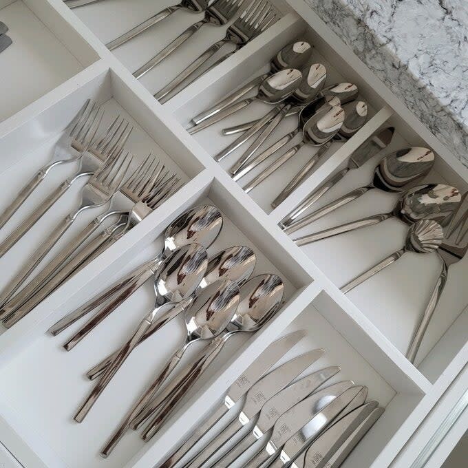 Organized drawer with various silverware sets, each in dedicated compartments for shopping article