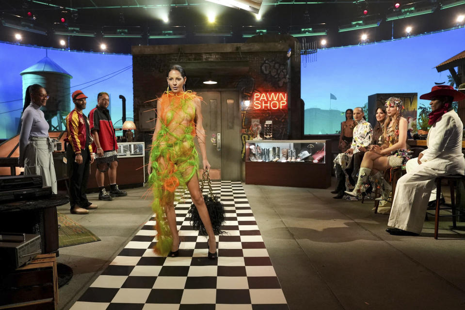 This image released by E! Entertainment shows a model wearing a design by Theodore Banzon in a scene from the fashion competition series "OMG Fashun." (Quantrell Colbert/E! Entertainment via AP)