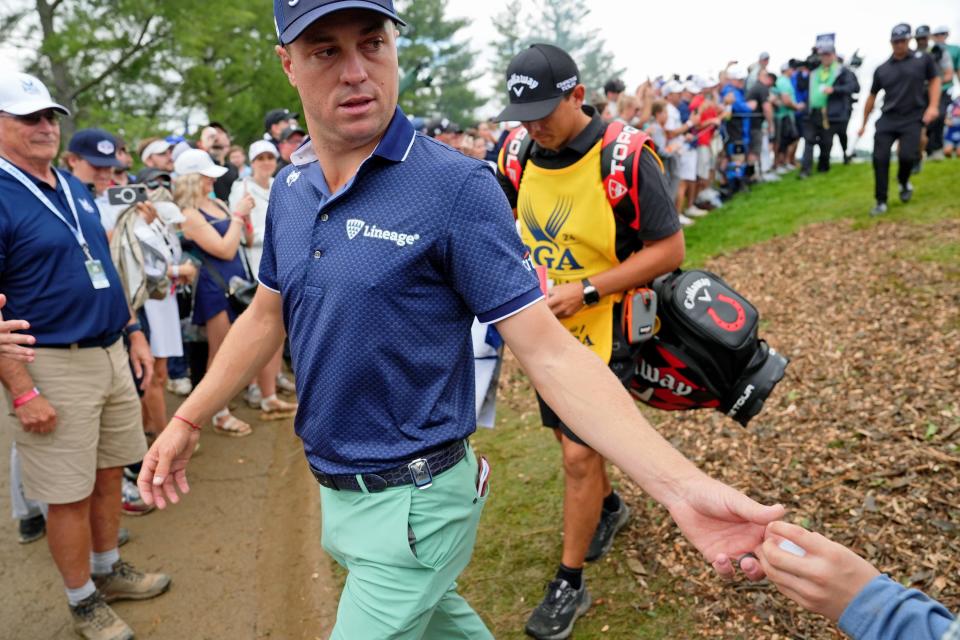 Justin Thomas gives a young fan a golf ball on his way to the eighth tee during the second round of the PGA Championship on Friday at Valhalla Golf Club.