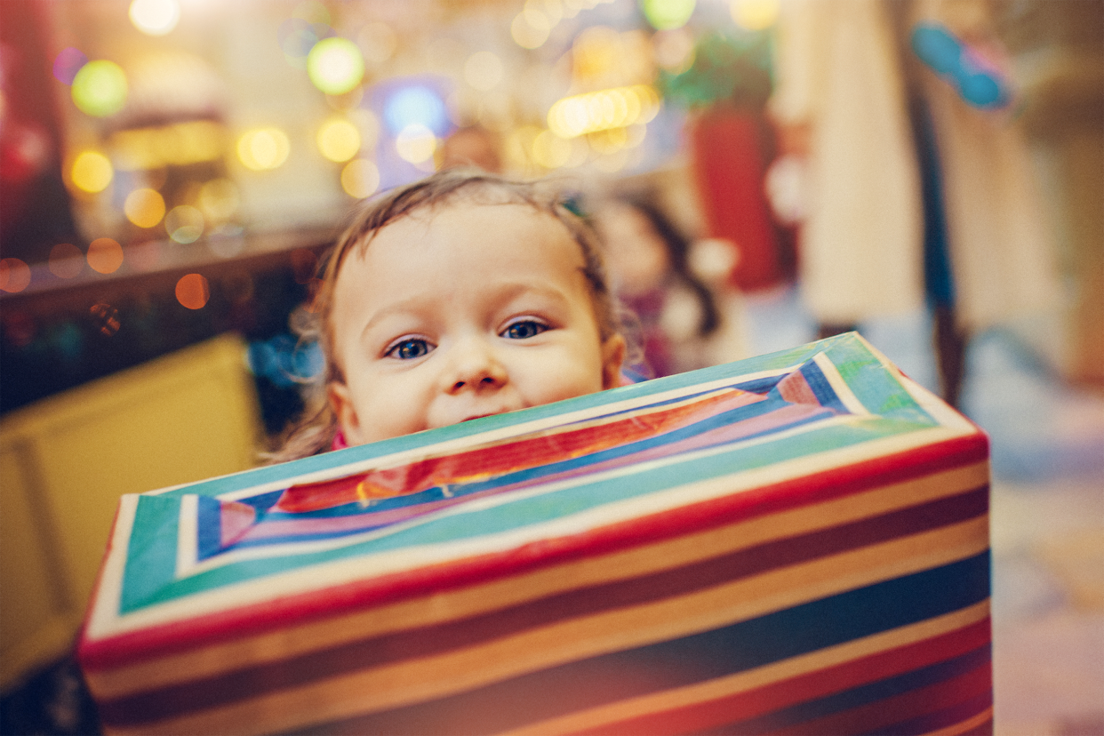 Little kid behind a gift box