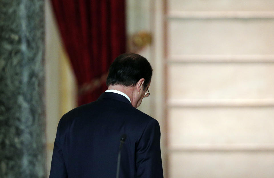 French President Francois Hollande leaves after his annual news conference, Tuesday, Jan.14, 2014 at the Elysee Palace in Paris. Hollande is promising to cut 50 billion euros in public spending over 2015-2017 to try to improve the indebted economy. Hollande, a Socialist, came to office in 2012 on pledges to avoid the painful austerity measures carried out by neighboring Spain and Italy. But France’s economy has suffered two recessions in recent years and growth is forecast at an anemic 0.2 percent in 2013. (AP Photo/Christophe Ena)