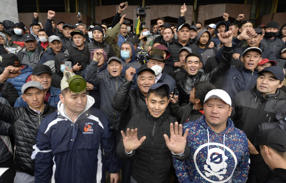 Protesters gather in front of the government headquarters on the central square in Bishkek, Kyrgyzstan, Tuesday, Oct. 6, 2020. Protesters have clashed with police in Kyrgyzstan's capital during a demonstration against the results of a parliamentary election. Early results in the election gave the majority of votes to two parties with ties to the ruling elites amid allegations of vote buying. (AP Photo/Vladimir Voronin)