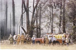 In this Daily American file photo, first responders examine the site where Flight 93 went down in Shanksville on Sept. 11, 2001.