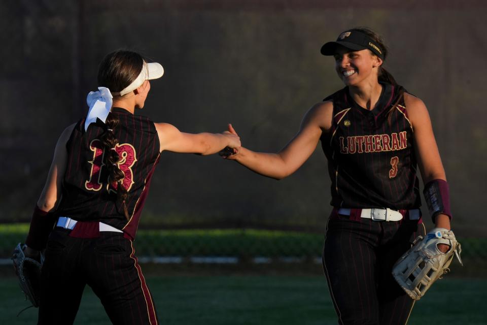 Lutheran Saints Maddux Tindall (13) and Lutheran Saints Grace King (3) celebrate after making an out against the Cascade Cadets on Tuesday, April 30, 2024, at Lutheran High School in Indianapolis. The Cascade Cadets defeated the Lutheran Saints 9-1.